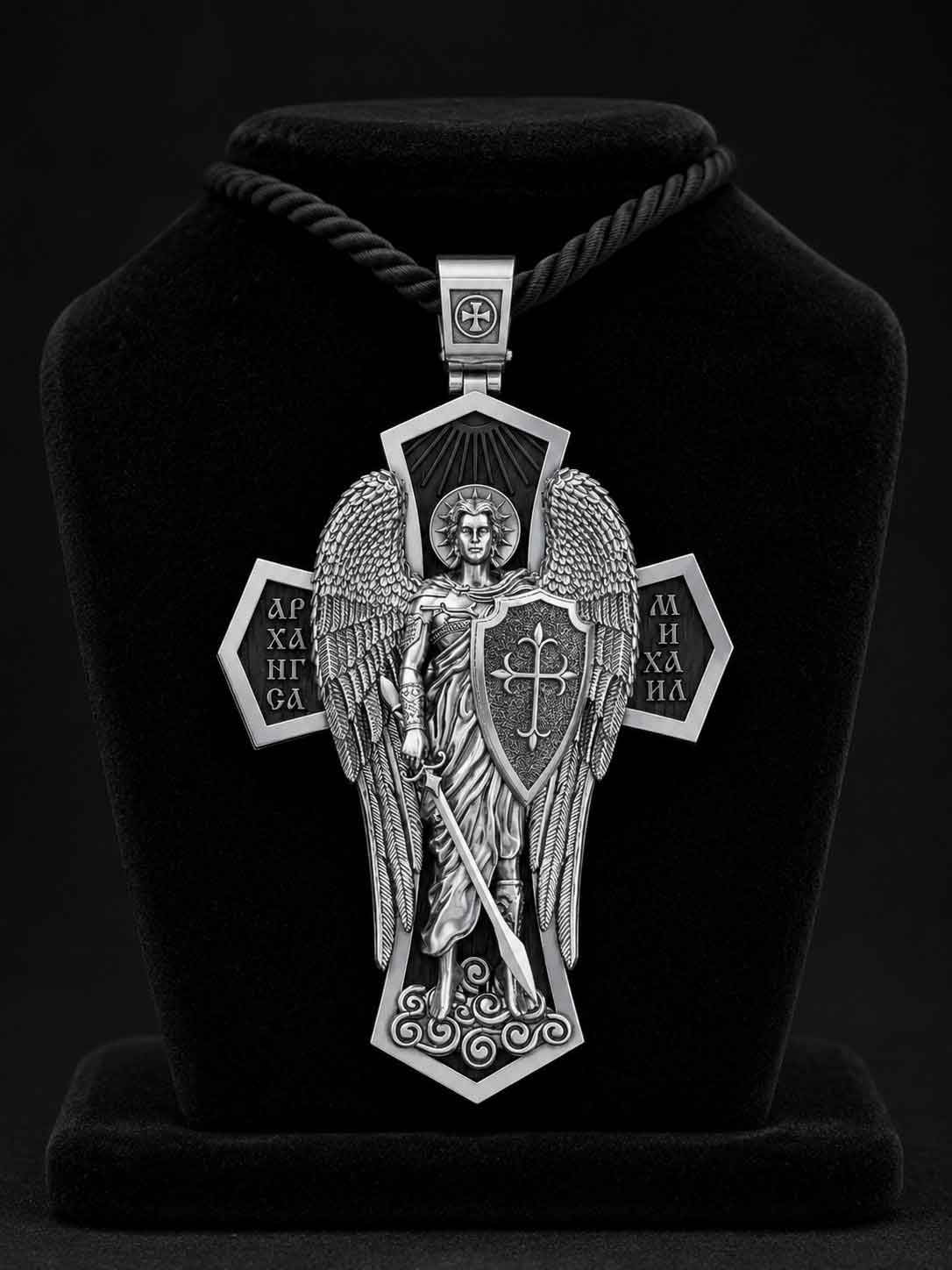 serebryanyj-pravoslavnyj-krest-ladanka-arkhangel-mikhail-i-svyatye-pokroviteli1 Detailed close-up studio photograph of the complex assembly of the silver and ebony cross pendant
